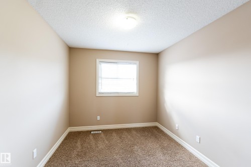 Carpeted empty room with a textured ceiling - 1118 162 Street, Edmonton, AB - Indoor Photo Showing Other Room