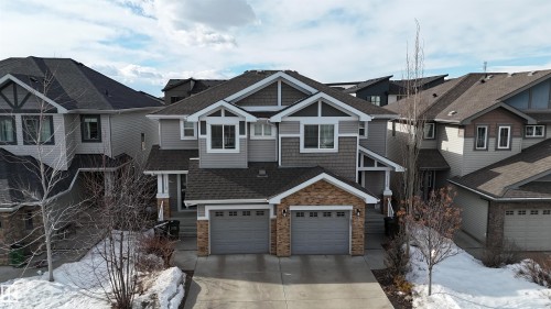 Craftsman inspired home with a shingled roof, concrete driveway, a residential view, and an attached garage - 1118 162 Street, Edmonton, AB - Outdoor With Facade