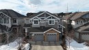 Craftsman inspired home with a shingled roof, concrete driveway, a residential view, and an attached garage - 1118 162 Street, Edmonton, AB  - Outdoor With Facade 