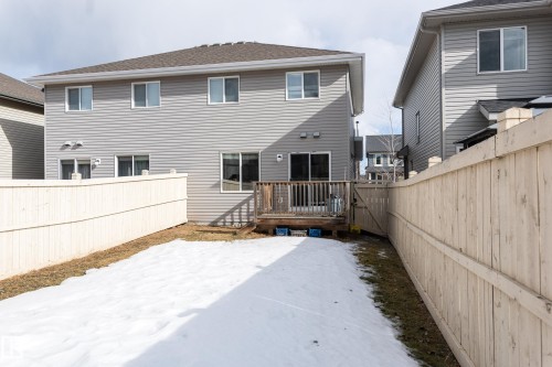 Rear view of property featuring a fenced backyard, a wooden deck, and roof with shingles - 1118 162 Street, Edmonton, AB - Outdoor With Exterior