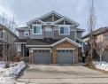 Craftsman-style home with concrete driveway, stone siding, an attached garage, and roof with shingles - 1118 162 Street, Edmonton, AB  - Outdoor With Facade 