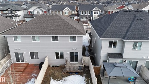 Back of property with roof with shingles, a deck, a residential view, and a patio - 1118 162 Street, Edmonton, AB - Outdoor