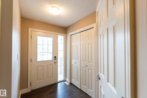 Foyer entrance with a textured ceiling and dark wood finished floors - 1118 162 Street, Edmonton, AB - Indoor Photo Showing Other Room