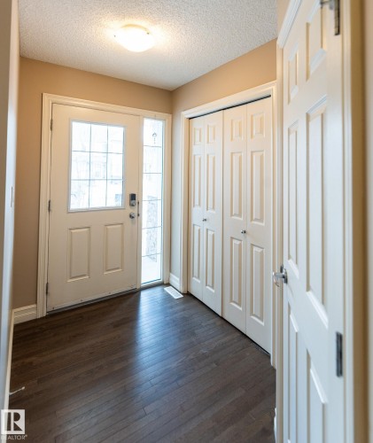 Entryway featuring dark wood-style flooring and a textured ceiling - 1118 162 Street, Edmonton, AB - Indoor Photo Showing Other Room