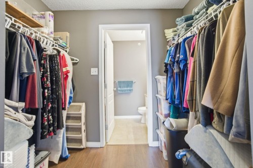 Walk in closet with light wood-type flooring - 421 155 Edwards Drive, Edmonton, AB - Indoor With Storage