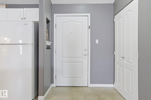 Hallway featuring baseboards and a textured ceiling - 421 155 Edwards Drive, Edmonton, AB - Indoor Photo Showing Other Room