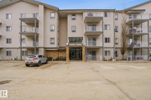 View of apartment building / complex featuring uncovered parking - 421 155 Edwards Drive, Edmonton, AB - Outdoor With Facade