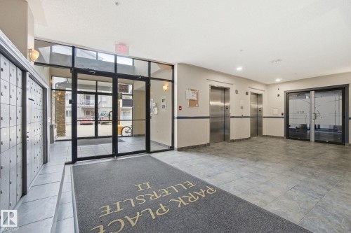 Building lobby with expansive windows - 421 155 Edwards Drive, Edmonton, AB - Indoor Photo Showing Other Room