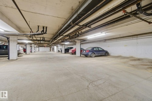 Garage with a parking garage - 421 155 Edwards Drive, Edmonton, AB - Indoor Photo Showing Garage