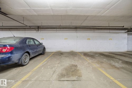 Garage featuring a parking garage - 421 155 Edwards Drive, Edmonton, AB - Indoor Photo Showing Garage