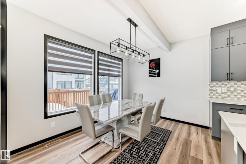 Dining area featuring light wood-type flooring and beam ceiling - 5110 23A Avenue, Edmonton, AB - Indoor Photo Showing Dining Room