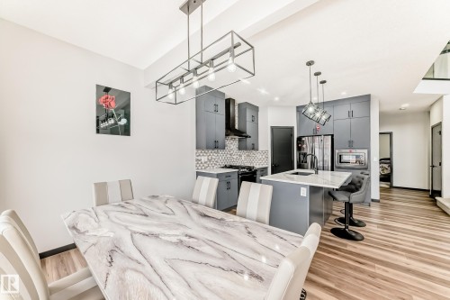 Dining area featuring light wood finished floors and baseboards - 5110 23A Avenue, Edmonton, AB - Indoor Photo Showing Dining Room