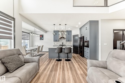 Living room featuring light wood finished floors and recessed lighting - 5110 23A Avenue, Edmonton, AB - Indoor Photo Showing Living Room