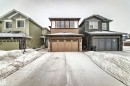 View of front of property featuring stone siding, driveway, and a garage - 5110 23A Avenue, Edmonton, AB  - Outdoor With Facade 