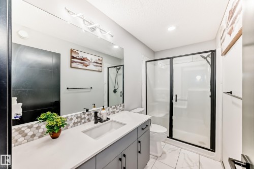Full bath featuring a stall shower, vanity, and light marble finish flooring - 5110 23A Avenue, Edmonton, AB - Indoor Photo Showing Bathroom