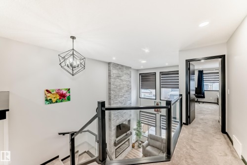 Corridor featuring an upstairs landing, light colored carpet, and suspended lighting - 5110 23A Avenue, Edmonton, AB - Indoor Photo Showing Other Room