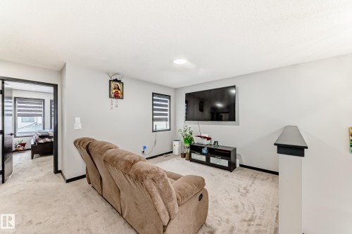 Living room featuring light colored carpet and baseboards - 5110 23A Avenue, Edmonton, AB - Indoor Photo Showing Living Room