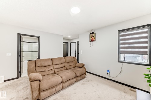 Living area with light carpet and baseboards - 5110 23A Avenue, Edmonton, AB - Indoor