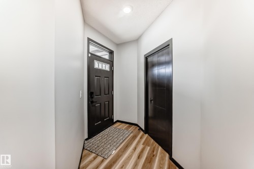Doorway featuring wood finished floors and baseboards - 5110 23A Avenue, Edmonton, AB - Indoor Photo Showing Other Room