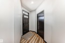 Doorway featuring wood finished floors and baseboards - 5110 23A Avenue, Edmonton, AB  - Indoor Photo Showing Other Room 