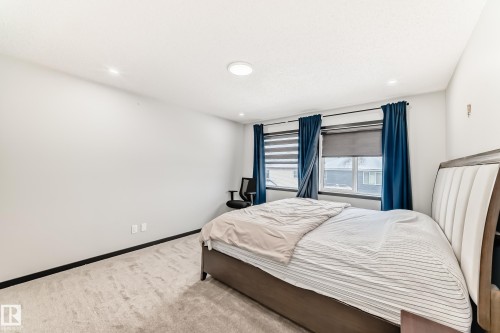 Carpeted bedroom featuring baseboards and recessed lighting - 5110 23A Avenue, Edmonton, AB - Indoor Photo Showing Bedroom