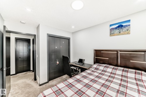 Bedroom with light colored carpet, a closet, a desk, and recessed lighting - 5110 23A Avenue, Edmonton, AB - Indoor Photo Showing Bedroom