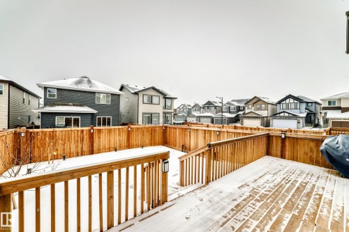 Deck with a residential view, a fenced backyard, and a grill - 5110 23A Avenue, Edmonton, AB - Outdoor With Deck Patio Veranda With Exterior