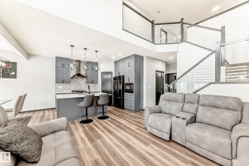 Living area with light wood finished floors and recessed lighting - 5110 23A Avenue, Edmonton, AB - Indoor Photo Showing Living Room