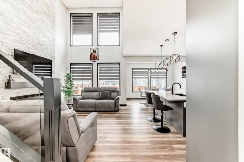 Living room with light wood-style floors and a high ceiling - 5110 23A Avenue, Edmonton, AB - Indoor