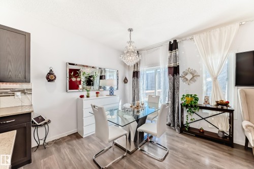 Dining area featuring light wood finished floors and a chandelier - 3059 Checknita Way, Edmonton, AB - Indoor Photo Showing Other Room