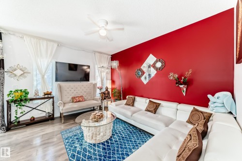 Living area featuring wood finished floors, an accent wall, and ceiling fan - 3059 Checknita Way, Edmonton, AB - Indoor Photo Showing Living Room
