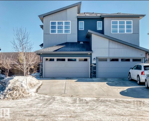 View of front of property with roof with shingles, driveway, and stone siding - 3059 Checknita Way, Edmonton, AB - Outdoor