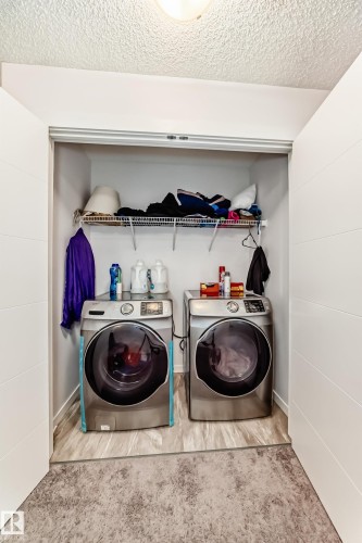 Laundry area featuring washing machine and clothes dryer and a textured ceiling - 3059 Checknita Way, Edmonton, AB - Indoor Photo Showing Laundry Room