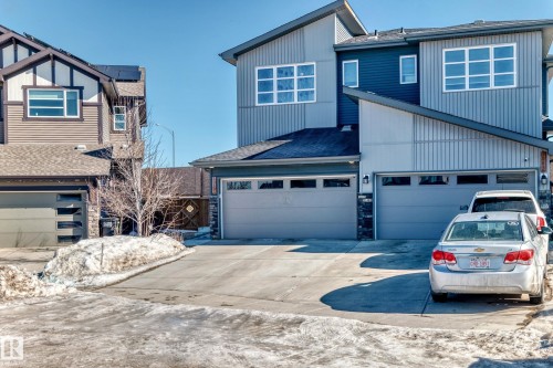 View of front of house with roof with shingles, concrete driveway, a garage, and stone siding - 3059 Checknita Way, Edmonton, AB - Outdoor