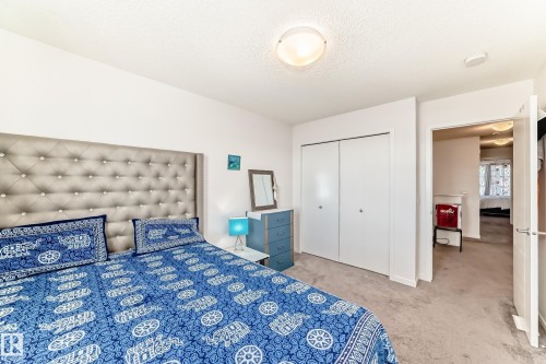 Bedroom with light colored carpet, a closet, and a textured ceiling - 3059 Checknita Way, Edmonton, AB - Indoor Photo Showing Bedroom