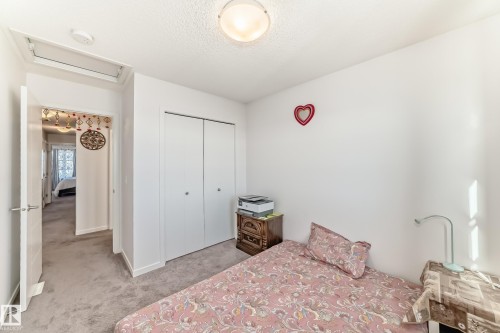 Bedroom featuring a closet, light carpet, and a textured ceiling - 3059 Checknita Way, Edmonton, AB - Indoor Photo Showing Bedroom