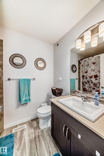Full bath featuring vanity, curtained shower, and light wood-style floors - 3059 Checknita Way, Edmonton, AB - Indoor Photo Showing Bathroom