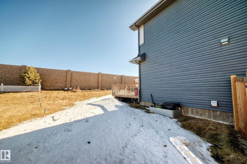 View of side of home featuring a fenced backyard and a deck - 3059 Checknita Way, Edmonton, AB - Outdoor