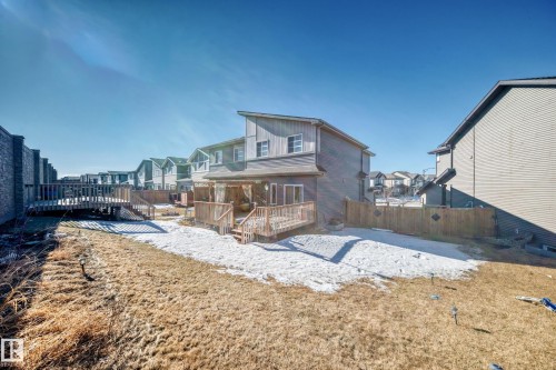 Rear view of property featuring a wooden deck, a residential view, and a fenced backyard - 3059 Checknita Way, Edmonton, AB - Outdoor