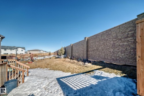 Fenced backyard featuring a residential view and a deck - 3059 Checknita Way, Edmonton, AB - Outdoor