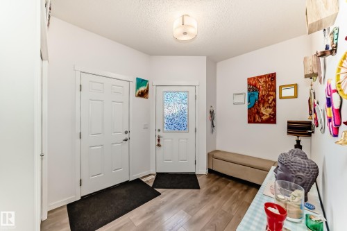 Foyer featuring light wood-type flooring and a textured ceiling - 3059 Checknita Way, Edmonton, AB - Indoor