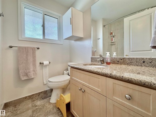 Full bathroom with vanity, a shower with shower curtain, and light stone finish flooring - 4 Wolf Crescent Nw, Edmonton, AB - Indoor Photo Showing Bathroom