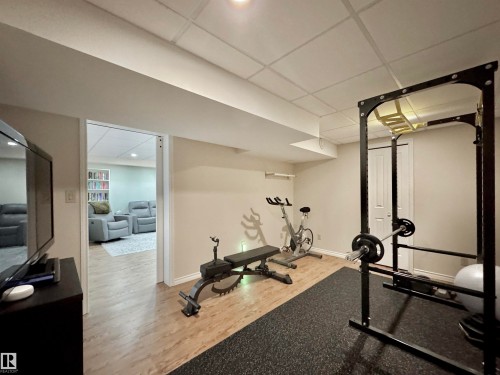 Workout area with light wood-type flooring and a drop ceiling - 4 Wolf Crescent Nw, Edmonton, AB - Indoor Photo Showing Gym Room