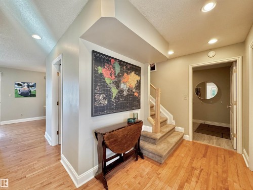 Hallway with light wood-style flooring, a textured ceiling, and recessed lighting - 4 Wolf Crescent Nw, Edmonton, AB - Indoor Photo Showing Other Room