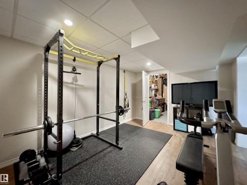 Workout room with light wood-style flooring, recessed lighting, and a drop ceiling - 4 Wolf Crescent Nw, Edmonton, AB - Indoor