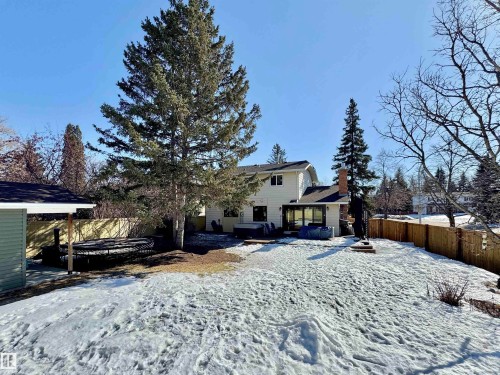 Snow covered house with a fenced backyard and a chimney - 4 Wolf Crescent Nw, Edmonton, AB - Outdoor