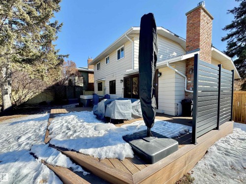 Snow covered back of property with a chimney and a deck - 4 Wolf Crescent Nw, Edmonton, AB - Outdoor