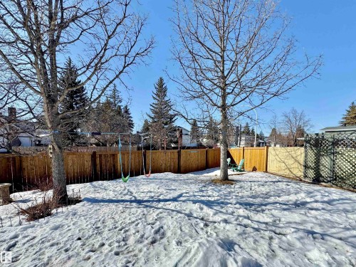Yard layered in snow with a fenced backyard - 4 Wolf Crescent Nw, Edmonton, AB - Outdoor With Backyard