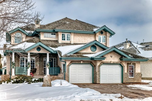 View of front of home featuring covered porch, a chimney, and brick siding - 170 Blackburn Drive W, Edmonton, AB - Outdoor With Facade
