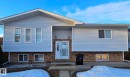 The property features light blue siding and a brick lower exterior - 4514 56 Avenue, Barrhead, AB  - Outdoor 